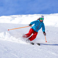 Skier skiing downhill during ski season on mountain