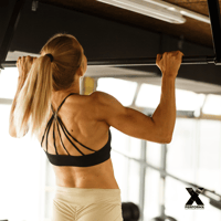 Woman doing pull ups during Murph Workout